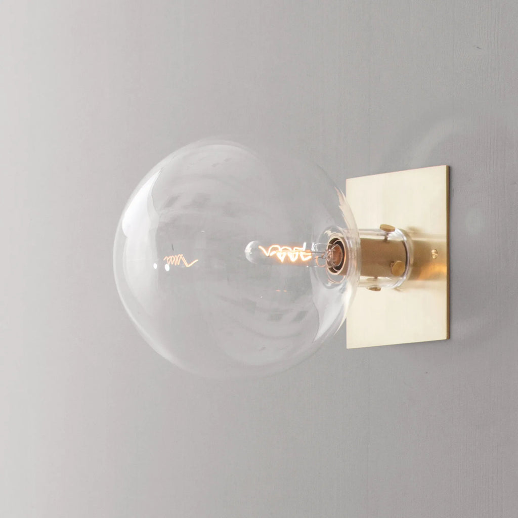 glass globe wall light in Brushed Oiled and Waxed brass ORA WALL 140 by KAIA